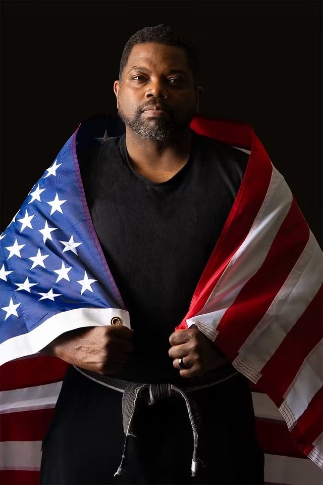 Instructor MJ wrapped in the American flag